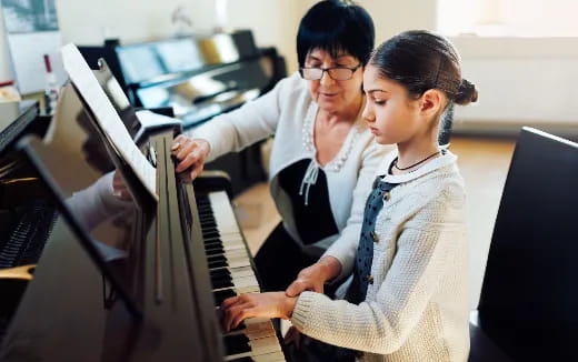 a couple of women working on a computer