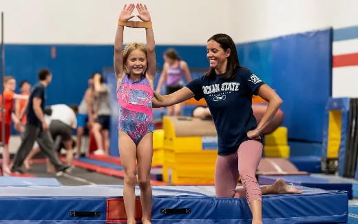 a person and a girl in a swimming pool