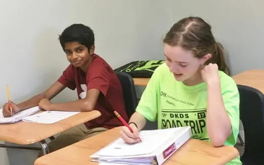 a few young women sitting at a table
