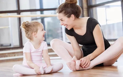 a woman and a child sitting on the floor