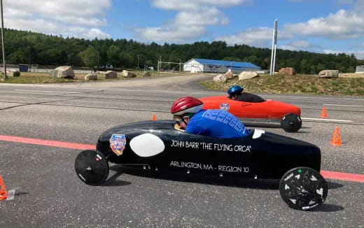 two people in go karts on a track