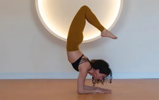 a woman doing a handstand