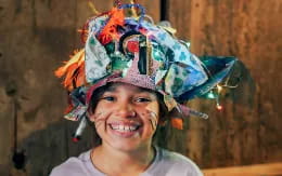 a boy wearing a colorful hat