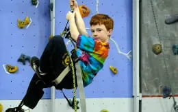 a boy climbing a wall