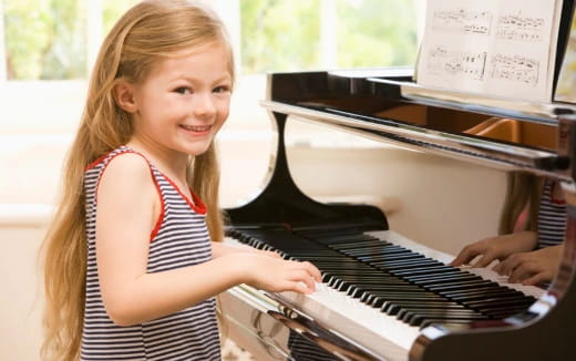 a girl playing a piano