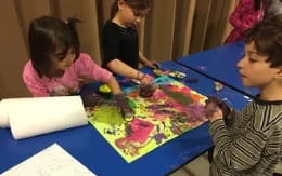 a group of children painting