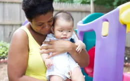 a person holding a baby