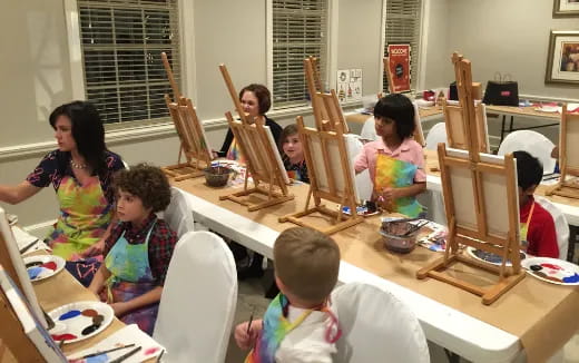 a group of children sitting around a table