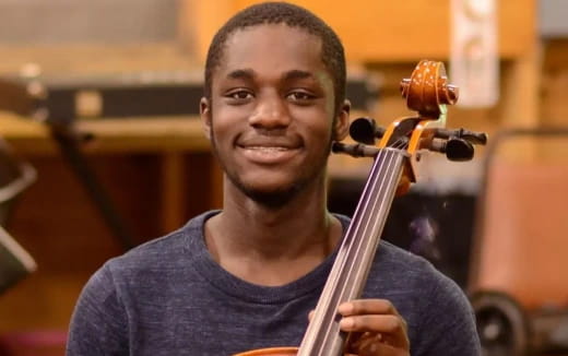 a man holding a violin