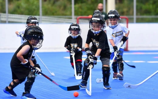 a group of kids playing hockey
