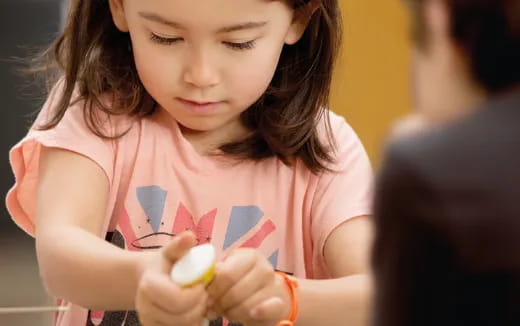 a girl holding a toy