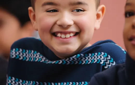 a close-up of a boy smiling