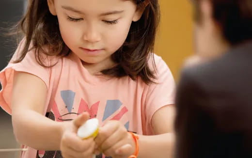 a girl holding a toy