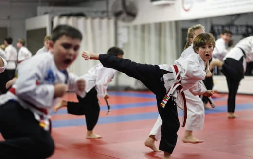a group of people in karate uniforms