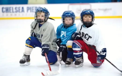 a group of people playing hockey