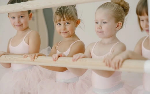 a group of children in white dresses