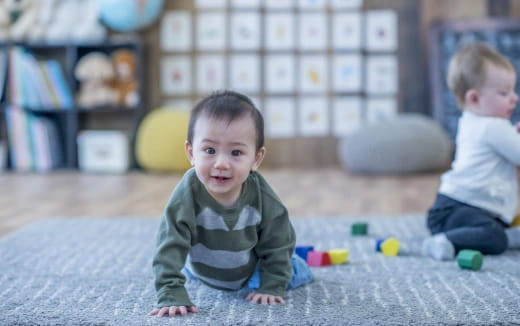 a baby crawling on the floor