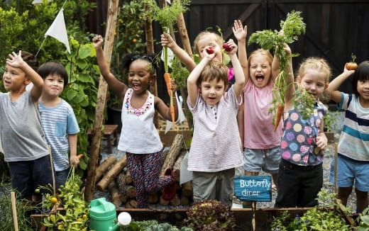 a group of children holding up their hands