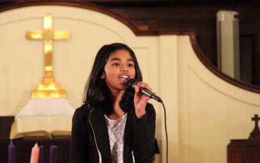 a person singing into a microphone