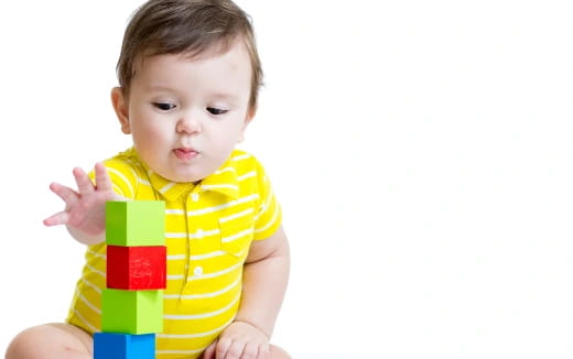 a baby holding a toy