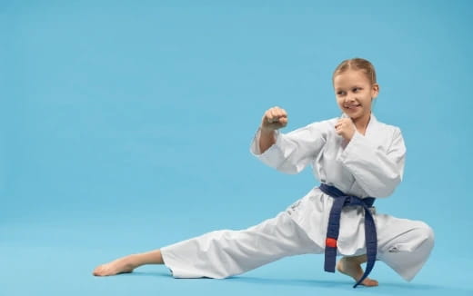 a young girl in a karate uniform