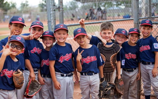 a group of kids in baseball uniforms
