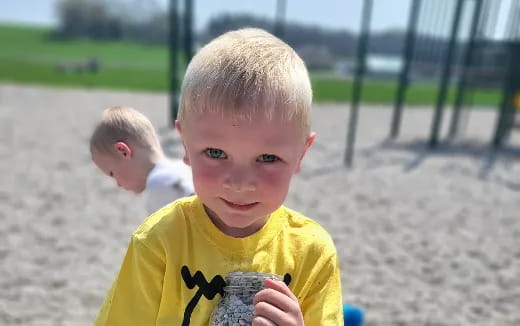 a boy holding a rock