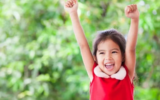 a girl with her arms raised