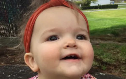 a baby with a red headband