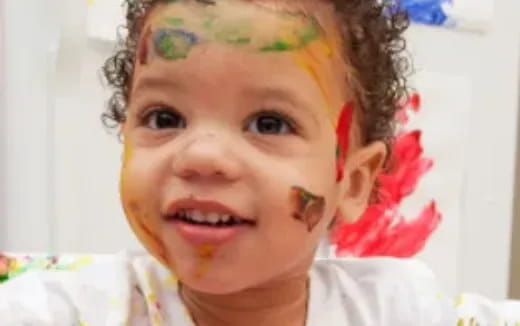 a child with a flower on her head