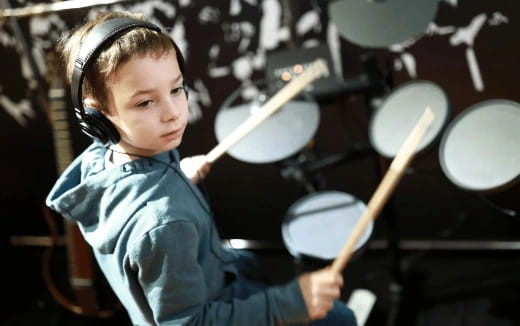 a young girl playing drums