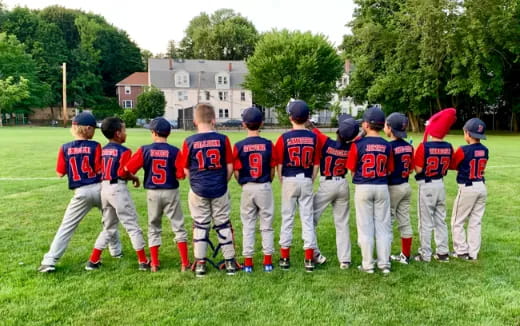 a group of kids in baseball uniforms
