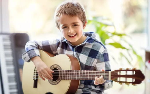 a boy playing a guitar