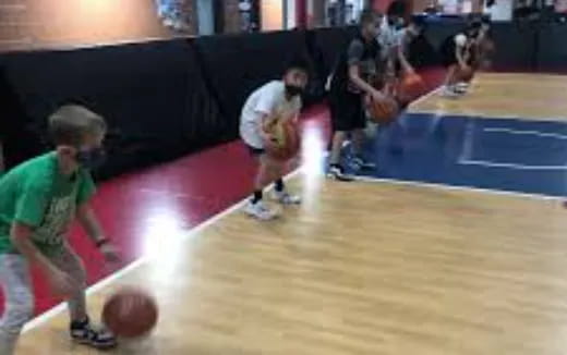 a group of people playing basketball