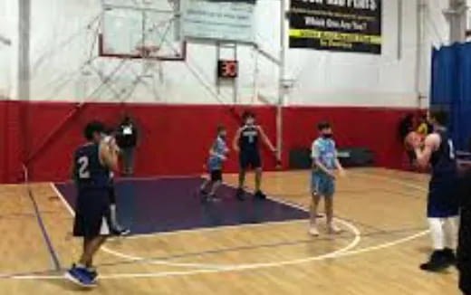 a group of people playing basketball