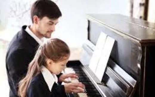 a man and a woman looking at a computer