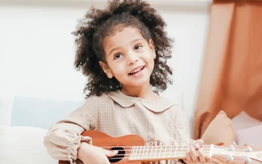 a child playing a guitar