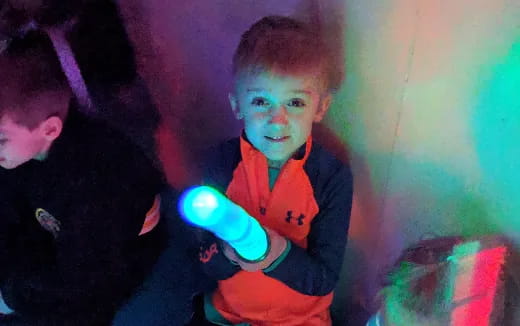 a boy holding a blue light