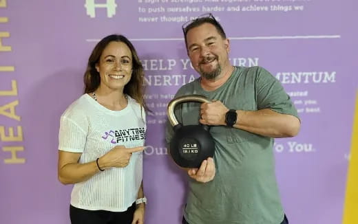 a man and woman holding helmets