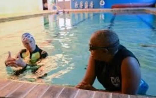 a man and a woman in a pool