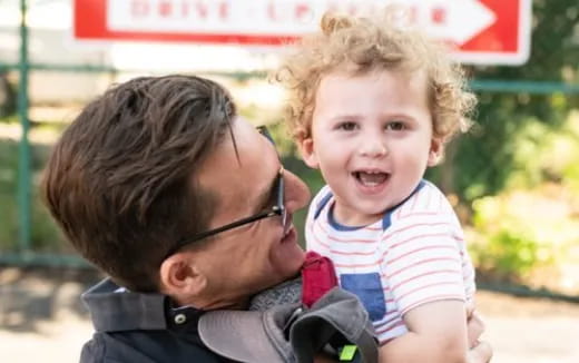 a person holding a child