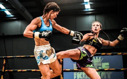 a man and a woman fighting in a boxing ring