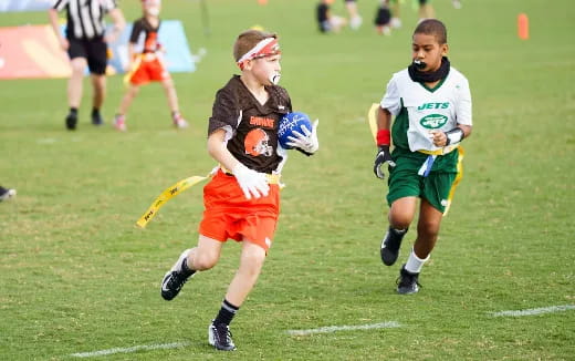 a group of kids playing football