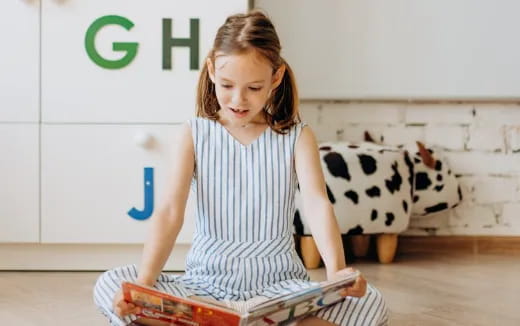 a girl holding a baby