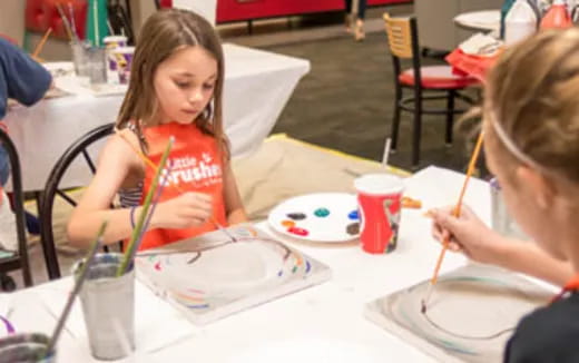 a couple of children painting