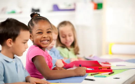 a group of children sitting at a table
