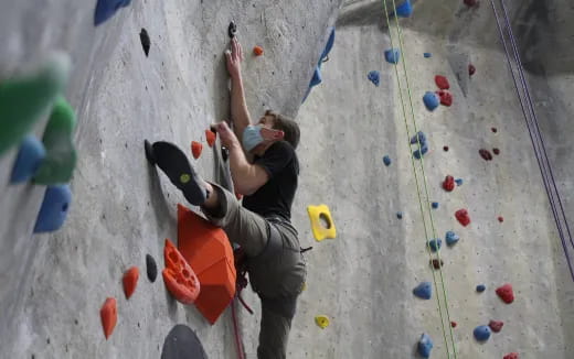 a man climbing a rock wall