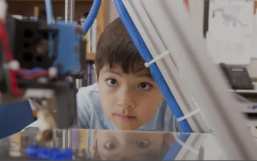 a young boy wearing a blue hoodie