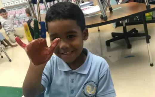 a boy holding up his fingers