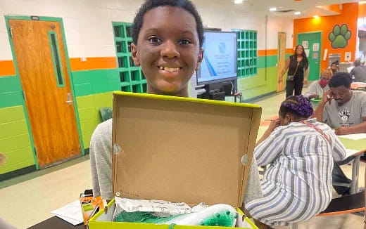 a boy holding a box